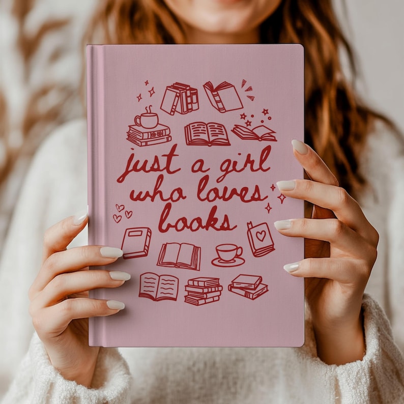 May include: A pink journal featuring the phrase "just a girl who loves books" in red script, adorned with book and coffee illustrations. Ideal for book enthusiasts, this journal makes a thoughtful gift.
