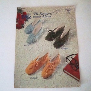 May include: A vintage crochet pattern booklet featuring four different crochet slipper designs. The booklet cover features the title "Hi-Steppers!" and the text "Designer Collection".