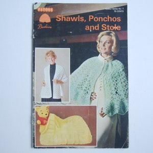 May include: A vintage Patons Beehive crochet pattern booklet featuring a green shawl, a white shawl, and a yellow baby blanket. The cover text reads "Shawls, Ponchos and Stole".