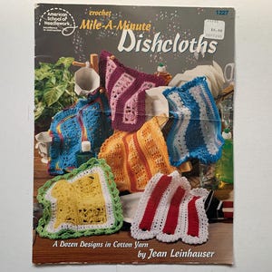 May include: A crochet pattern booklet for making a dozen different dishcloths. The cover features a colourful array of crocheted dishcloths in various colours and patterns, including red, white, blue, yellow, green, and purple.