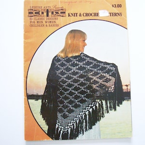 Może przedstawiać: Okładka książki przedstawiająca kobietę w czarnym, haftowanym szalu z frędzlami. Tekst na okładce brzmi: "Leisure Arts Presents British Knit & Crochet Patterns 68 Classic Designs for Men, Women, Children & Babies 3,00 €"