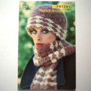 May include: A vintage fashion accessories book cover showing a woman modelling a knitted hat and scarf set. The hat and scarf are in shades of brown and cream. The cover displays the text "PATONS Fashion Accessories".