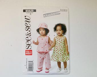 See & Sew B5629 5629 Patrón sin cortar Talla infantil A - Recién nacido S M L Vestido sin mangas Top de verano Braguitas Pantalones bombachos Sombrero de cubo Muy fácil