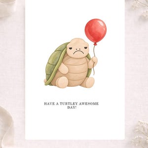 May include: A greeting card featuring a watercolor illustration of a tan turtle with a green shell holding a red balloon. The turtle has a sad facial expression. Below the illustration, the text reads: HAVE A TURTLEY AWESOME DAY!