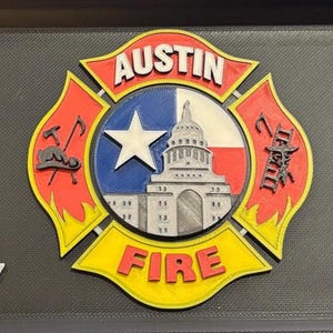 May include: A red, yellow, and blue fire department emblem with the words "Austin Fire" and a stylized image of the Texas state capitol building.
