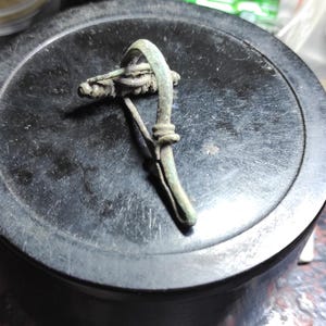 Ancient bronze Roman fibula brooch 2-4 century. Ancient Roman brooch for clothing. Archaeological artifact