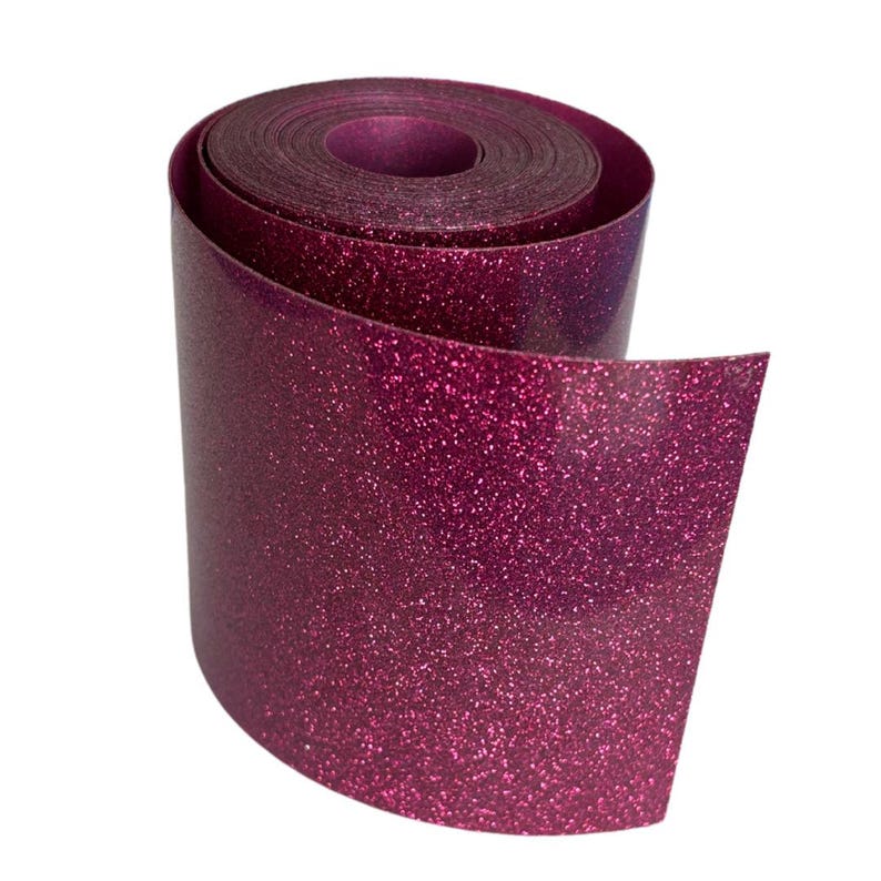May include: A roll of shimmering, magenta glitter vinyl. The vinyl is tightly rolled, with the end of the roll unfurled, revealing the glittery surface. The material has a smooth, reflective quality, ideal for crafting and decorative projects.