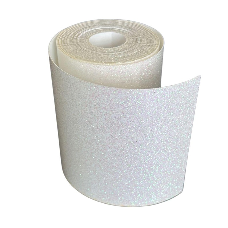 May include: A roll of white glitter tape, unrolled to reveal the sparkly texture. The tape is a bright white with iridescent glitter, creating a shimmering effect. The roll is tightly wound, showing the layers of tape.