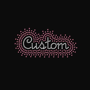 May include: The word "Custom" spelled out in white rhinestones, surrounded by a border of pink rhinestones, against a black background. The design is in a cursive font.