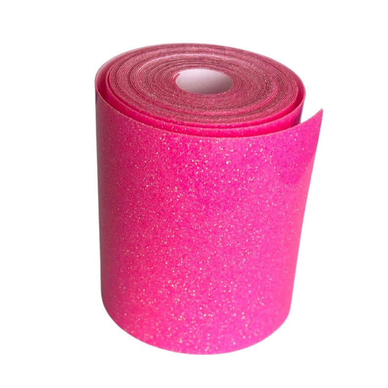 May include: A roll of bright pink glitter tape. The tape is tightly wound, revealing a white cardboard core. The surface of the tape is covered in sparkling glitter, catching the light and creating a shimmering effect.