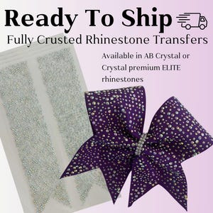 May include: A purple bow with clear rhinestones, ready to ship. The bow is fully covered in rhinestones and is available in AB Crystal or Crystal premium ELITE rhinestones.  Ready To Ship. Fully Crusted Rhinestone Transfers. Available in AB Crystal or Crystal premium ELITE rhinestones.