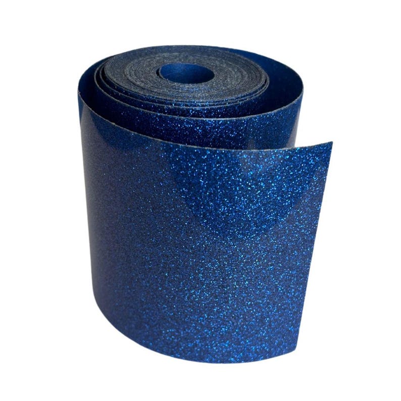 May include: A roll of blue glitter vinyl material. The vinyl is rolled up, revealing the shiny, textured surface. The material is a deep blue color with sparkling glitter embedded throughout.
