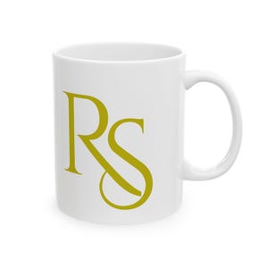 May include: White ceramic mug with a gold 'RS' monogram.