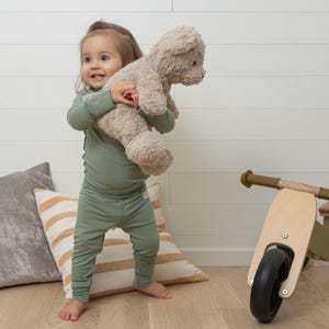 Toddler Wearing Green Bay Allergy-friendly Baby Bodysuit From SOOTHLA.