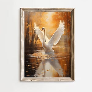 Puede incluir: Un cisne blanco con las alas extendidas, de pie en un estanque tranquilo con un reflejo del cisne en el agua. El fondo es una imagen borrosa de árboles con hojas doradas.