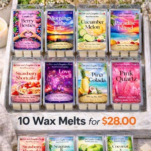 May include: A collection of ten soy wax melts in various scents, displayed in a wooden tray. Each melt is in a clear plastic container with colorful labels featuring images like fruit, landscapes, and the text "Love and Laughter Candle Co."