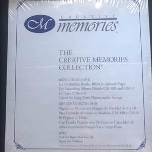 May include: A white package with blue text that reads "Creative Memories Collection" and "Refill RCM-10HB". The package contains 8 x 10 holiday border blank scrapbook pages for expanding album models CM-10B and CM-10. The package is acid free, lignin free, and buffered.