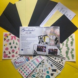 May include: A graduation scrapbook kit with a black and white photo album, stickers, and paper embellishments. The kit includes a variety of colors, including black, white, yellow, green, and pink. The kit also includes a variety of shapes, including stars, hearts, and graduation caps.