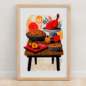 Thanksgiving table folk art print with a roast turkey, pies and pumpkins, framed in light oak