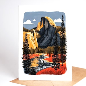 May include: A rectangular greeting card featuring a stylised illustration of Half Dome in Yosemite National Park. The scene depicts a winding river, tall evergreen trees, and golden mountain peaks under a blue sky with white clouds.