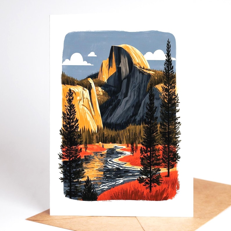 May include: A rectangular greeting card featuring a stylised illustration of Half Dome in Yosemite National Park. The scene depicts a winding river, tall evergreen trees, and golden mountain peaks under a blue sky with white clouds.