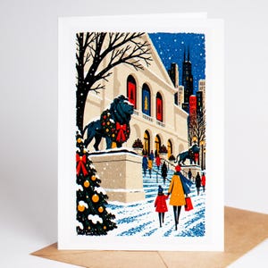 Chicago Christmas card standing with envelope, the Art Institute lions wearing holiday wreaths