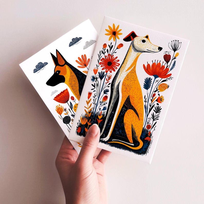 May include: Two rectangular greeting cards featuring stylized illustrations of dogs. One card shows a tan and black dog sitting among vibrant orange and red flowers. The other card displays a black and tan dog head with small clouds.