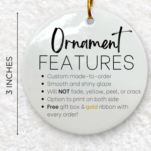 May include: A white, round ornament with the text "Ornament FEATURES" and bullet points describing the product's features. The ornament is 3 inches in diameter and has a gold ribbon for hanging.