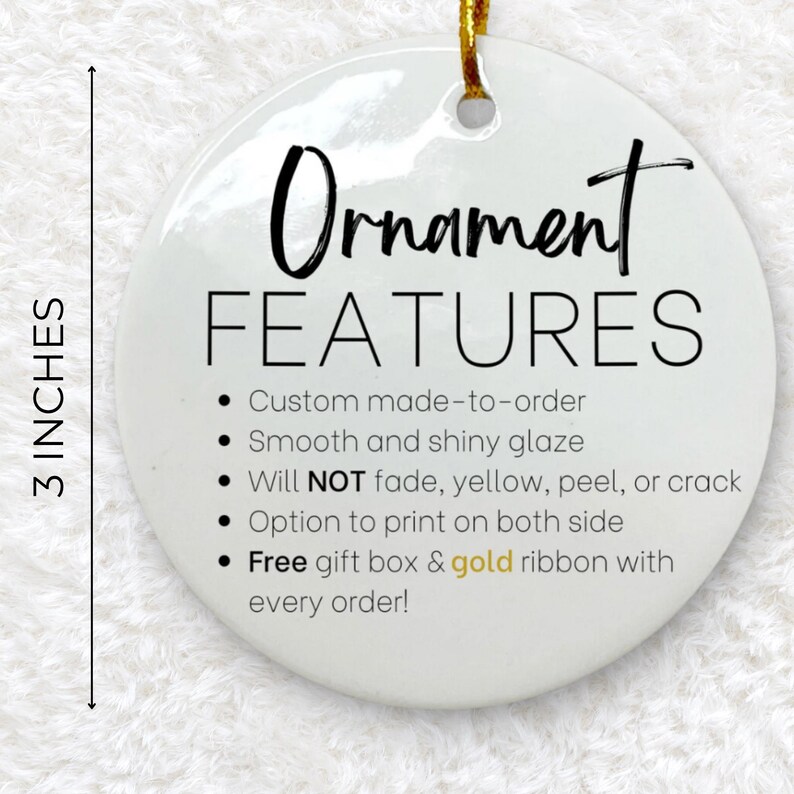 May include: A white, round ornament with the text "Ornament FEATURES" and bullet points describing the product's features. The ornament is 3 inches in diameter and has a gold ribbon for hanging.