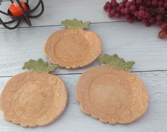 Handmade pumpkin dishes with fall leaves and acorns