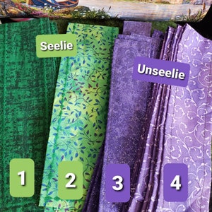 May include: Four fabric strips, two green and two purple, with numbers 1 through 4 printed on them. The green strips are labeled "Seelie" and the purple strips are labeled "Unseelie".