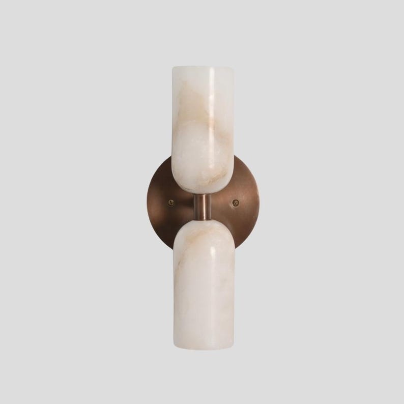 Handmade brass wall sconce with dual alabaster shades
