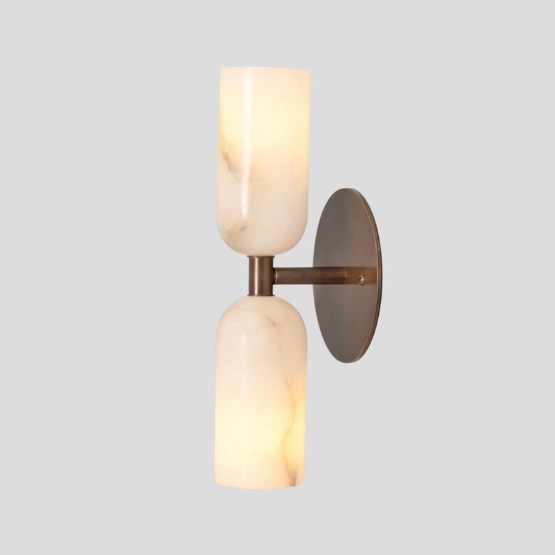 Double alabaster wall light with warm ambient glow