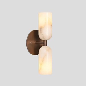 Double alabaster wall light with warm ambient glow