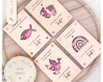 May include: A collection of wooden baptism cards with German text and currency art designs, such as footprints, a fish, a rainbow, and a dove. The cards are displayed on a wooden tray, alongside a digital download label. Each card has a different design.