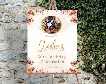 Può includere: Benvenuti alla festa di compleanno per i 50 anni di Amelia, un cartello con un design floreale e una foto di persone che festeggiano.