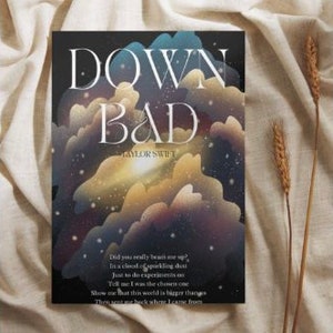 May include: A book cover with a dark blue background and a galaxy-like image of clouds and stars. The title "DOWN BAD" is written in white, with "TAYLOR SWIFT" in smaller white text below. The text "Did you really beam me up? In a cloud of sparkling death Just to do experiments on Tell me I was the chosen one Show me that this world is bigger than Then sent me back where I came from" is printed in white at the bottom of the cover.