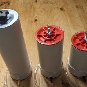 May include: Three white cylindrical containers with red lids and silver tops. The lids have the text "CAUTION: HANDLE WITH CARE" and "1.1 Liters (37 oz) Capacity".