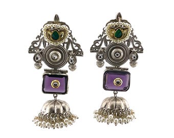 May include: Silver earrings with a purple stone, green and gold accents, and pearl details.