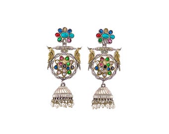 May include: A pair of silver-toned earrings with colorful gemstone accents. Each earring features a floral design with a central cluster of gems, a bird motif, and a dangling bell-shaped bottom with small pearl-like beads.