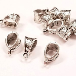 May include: A group of silver-toned metal pendant bails, some are open and some are closed. The bails are designed with a textured, woven pattern.