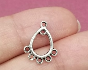May include: Silver teardrop-shaped pendant with a loop at the top and five small circles around the bottom.