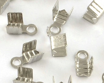 May include: Silver-toned metal clasps with a loop on one end. The clasps are designed to be used for jewelry making.