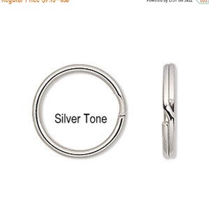 May include: Silver tone key ring with a round shape. The key ring is shown from the front and side.