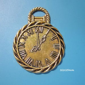 May include: Gold-tone metal clock charm with Roman numeral markings and a rope-like border. The clock face is 32mm x 25mm.