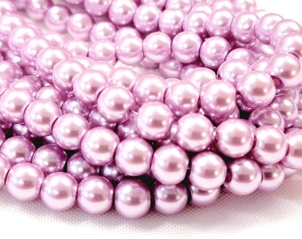 May include: A strand of light purple pearl beads. The beads are round and have a smooth, glossy finish.