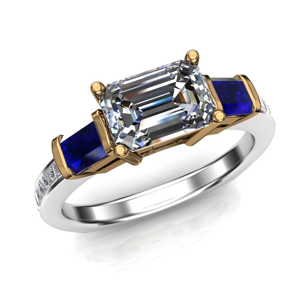 Emerald cut diamond with 2024 sapphire side stones