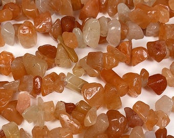 May include: A strand of orange, yellow, and white chip gemstone beads. The beads are irregular in shape and have a natural, polished finish.