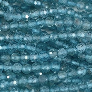 May include: A strand of light blue faceted gemstone beads. The beads are round and have a smooth, polished finish.