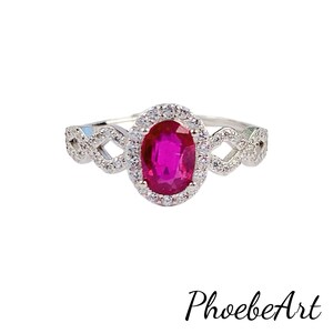 May include: A silver ring with a large oval ruby surrounded by smaller diamonds. The band is a delicate, twisted design.